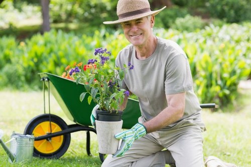 Gardener pruning shrubs in Queens Park